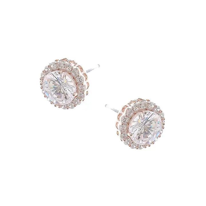 Rose gold earrings with large clear gemstones on a white background