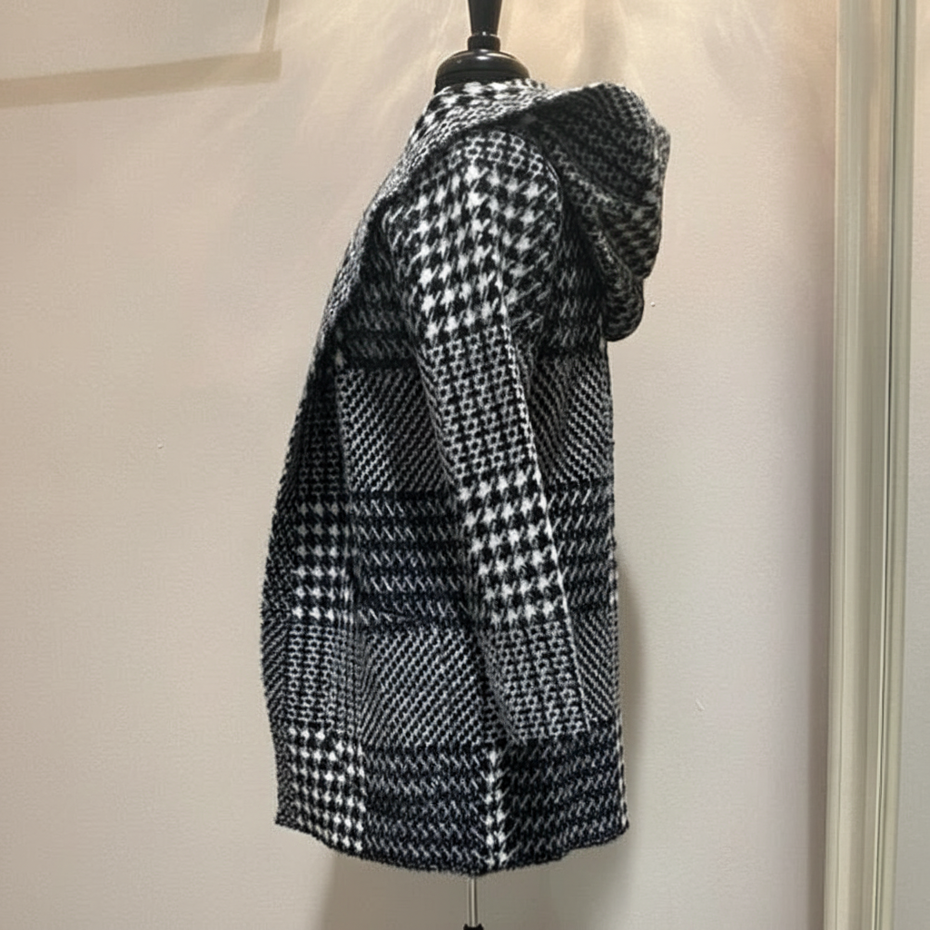 Black and white houndstooth hooded coat in eyelash mink fabric, right side profile showing hood drape and mixed geometric patterns on dress form
