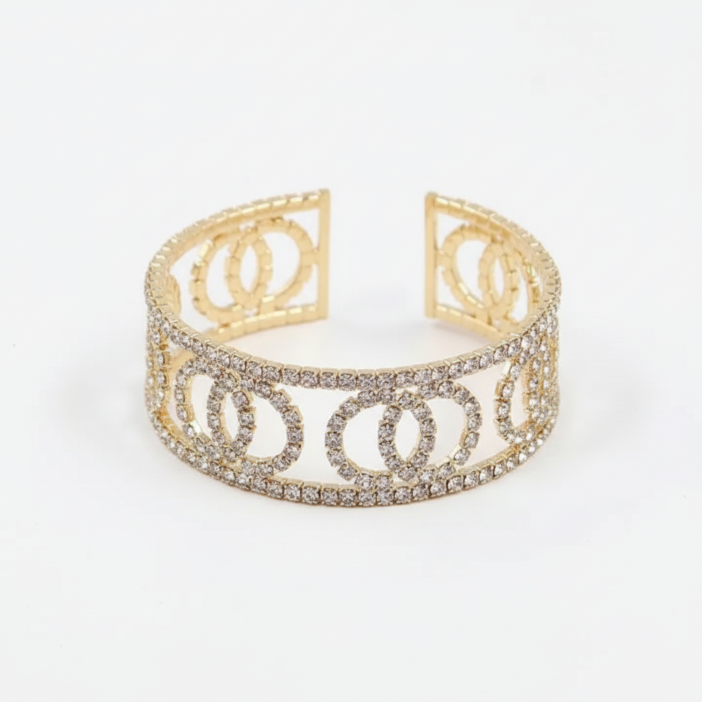 Rhinestone cuff bracelet with interlocking circle pattern and small adjustable opening, hero shot on white background showing crystal pavé detail