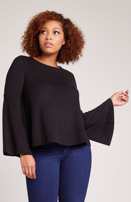 Black bell sleeve top on model - front view showing relaxed fit and dramatic flared sleeves