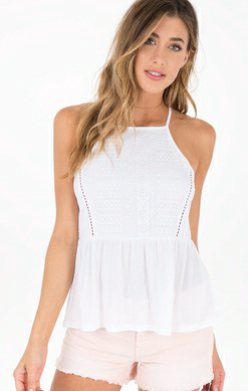 Woman wearing a white halter top with lace details on a white background