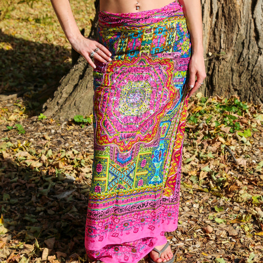 Woman wearing fuchsia mandala print wrap sarong as a floor-length maxi skirt outdoors – boho beach coverup and resort wear