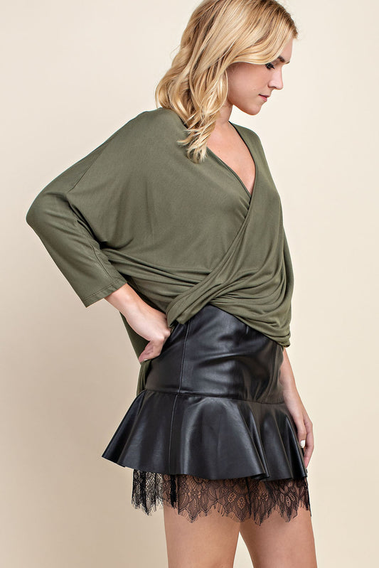  stylish olive drape top paired with a black leather skirt, creating a chic and modern look. The top is designed with a versatile, draped design that enhances its elegant appeal, suitable for both formal and casual settings.