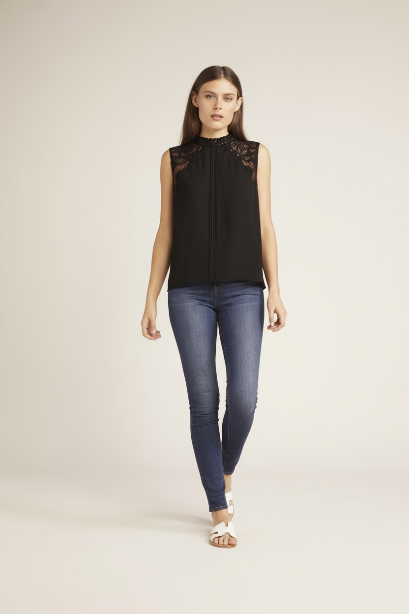 Model wearing black sleeveless top with lace shoulder detail paired with dark jeans - full body front view