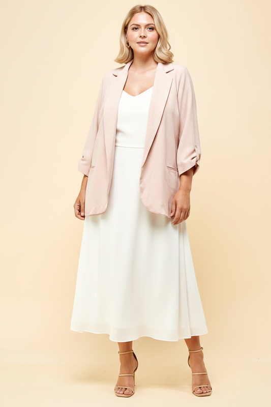 Plus size blush open-front blazer studio editorial – ruched sleeve longline blazer styled over ivory midi dress with nude heeled sandals