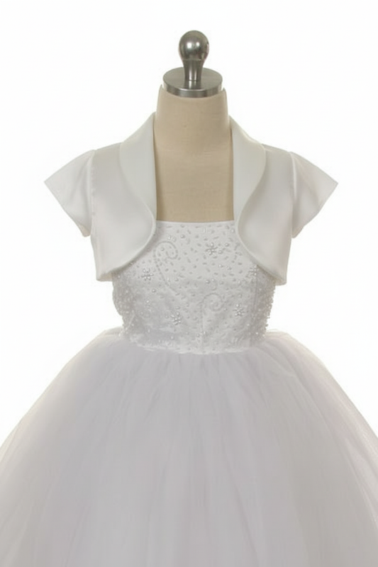 White satin bolero jacket with short sleeves on mannequin over white embellished flower girl dress
