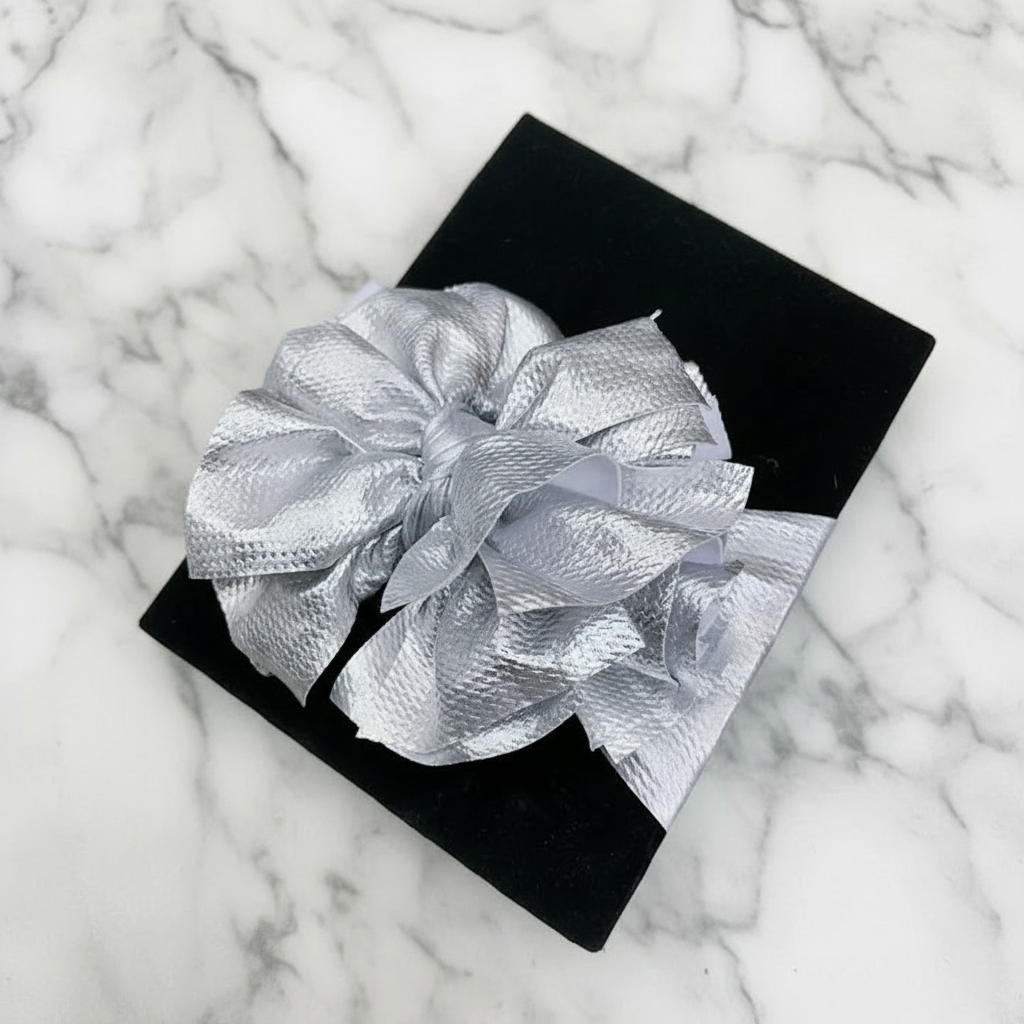 Metallic silver oversized bow headband on black gift box, 14-inch headband with 7-inch bow
