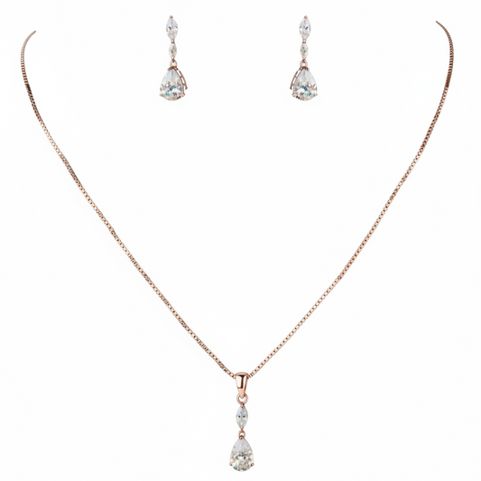 Rose gold necklace with teardrop pendant and matching earrings on a white background