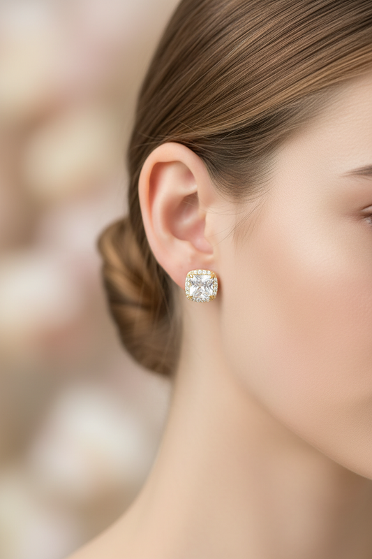 Editorial close-up of delicate CZ stud earrings
