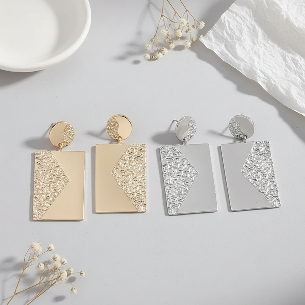 Flat lay with silver and gold earrings
