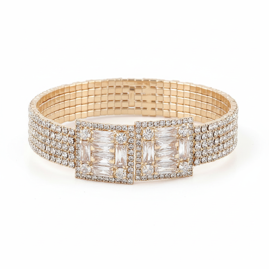 Gold crystal block bracelet front view showing rectangular rhinestone centerpiece with baguette and pavé crystals, bright white background, professional studio lighting
