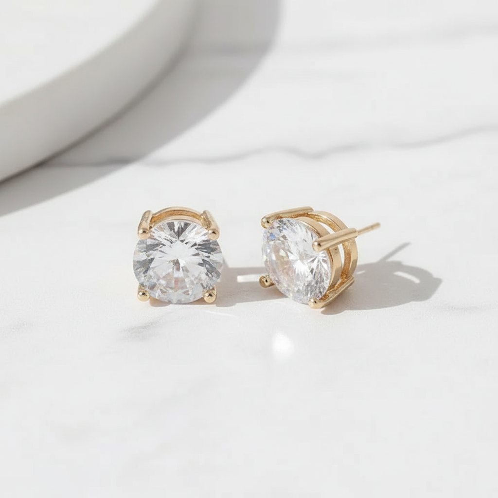 Gold cubic zirconia stud earrings flat lay