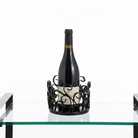 Black metal decorative scrollwork wine bottle coaster on glass bar cart with wine bottle, white background product hero shot