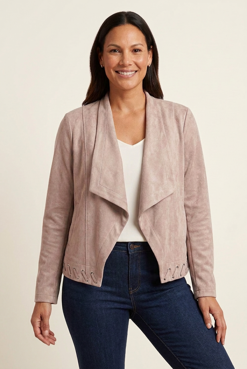 Front view of blush faux suede waterfall jacket with long sleeves and lace-up hem, styled with an ivory camisole and dark jeans.