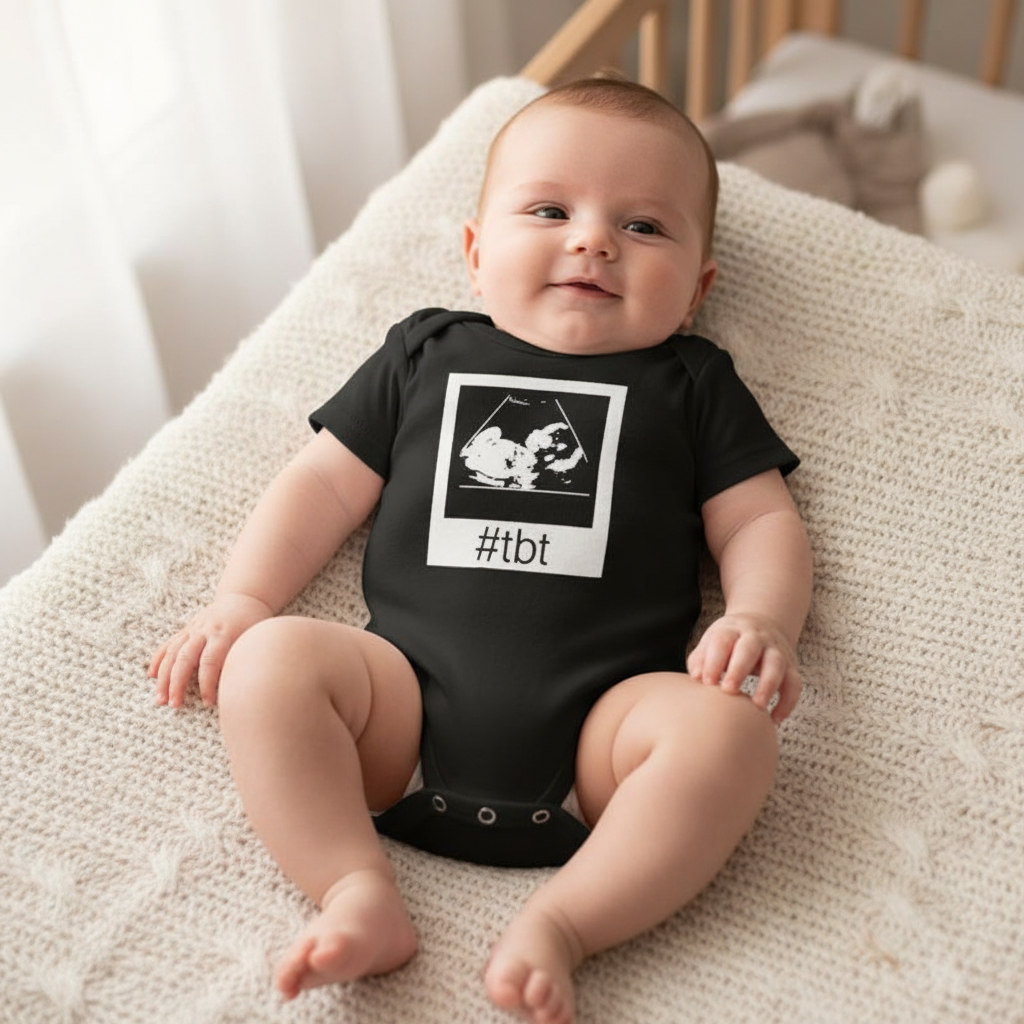 Infant wearing black baby onesie with white polaroid ultrasound graphic and #tbt text, premium boutique baby photography, funny baby shower gift onesie
