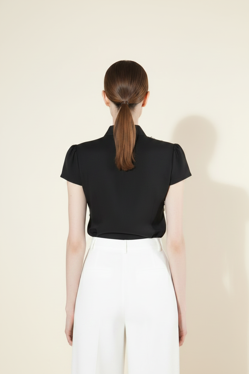 Black sequin fringe crop top back view showing smooth clean black fabric