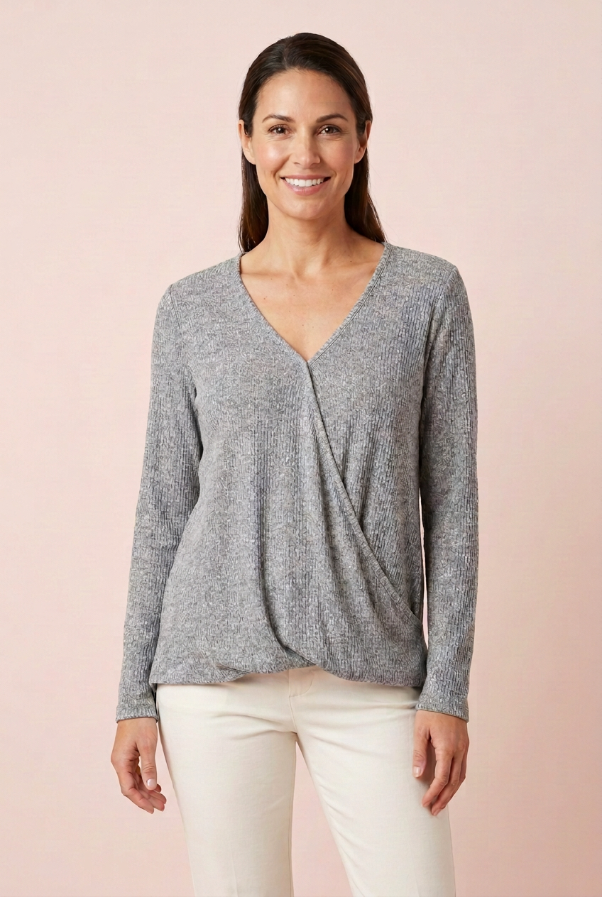 Heather gray ribbed surplice long sleeve top with folded-under front drape, styled with ivory trousers for everyday wear, front view
