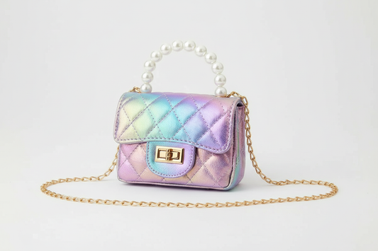 Mermaid iridescent quilted mini purse with rainbow holographic finish, pearl handle and gold chain strap on white background, professional studio product photography
