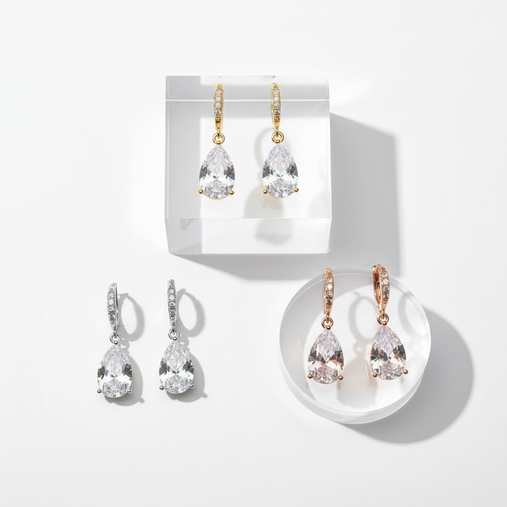 Multi-level flat lay - teardrop crystal earrings in gold, silver, and rose gold