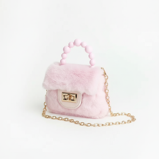 Pink faux fur purse with pearl beaded handle, gold chain strap, and faux leather front flap with turn-lock closure, professional studio product photography on white backdrop