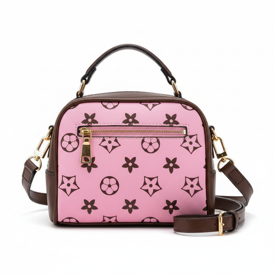Vibrant pink monogram crossbody bag with brown trim, star and flower pattern on white background