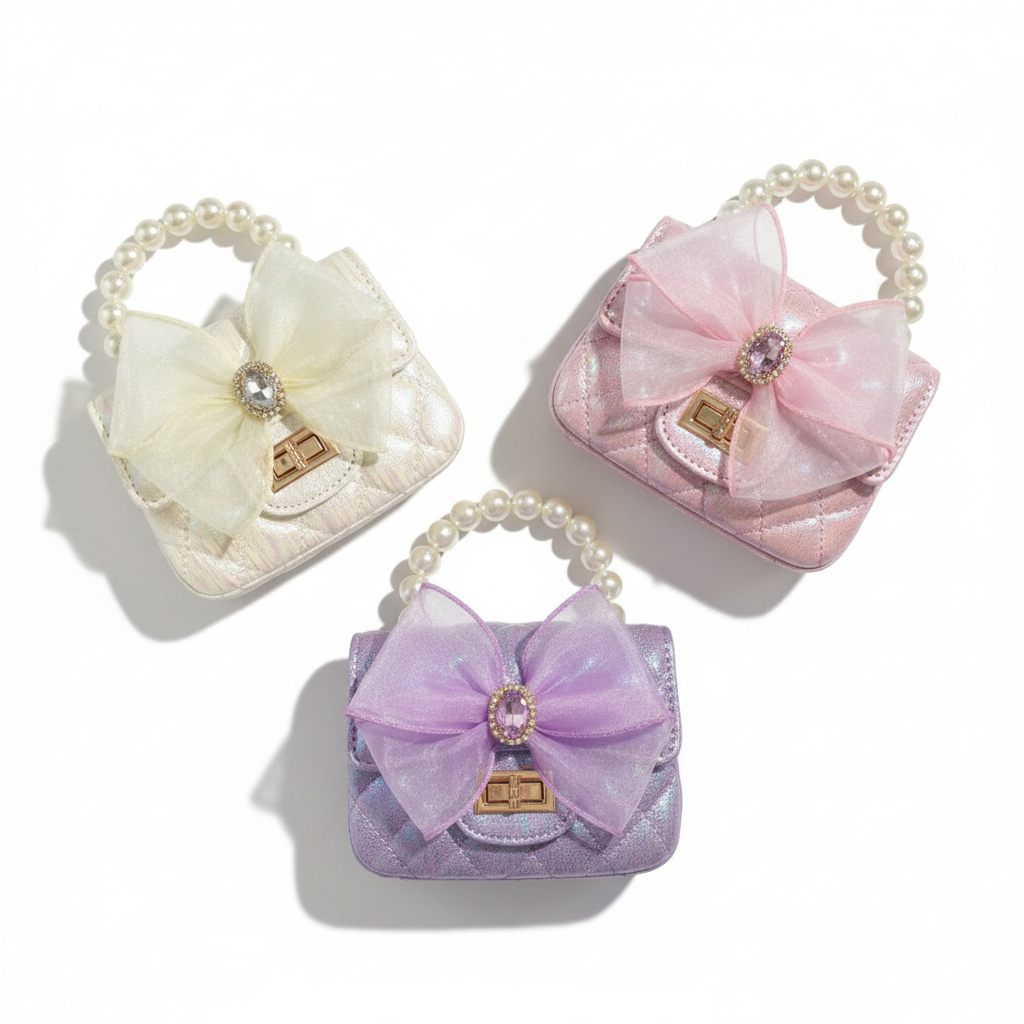 Flat lay of quilted mini purses with pearl handles in pink, purple, and ivory colors
