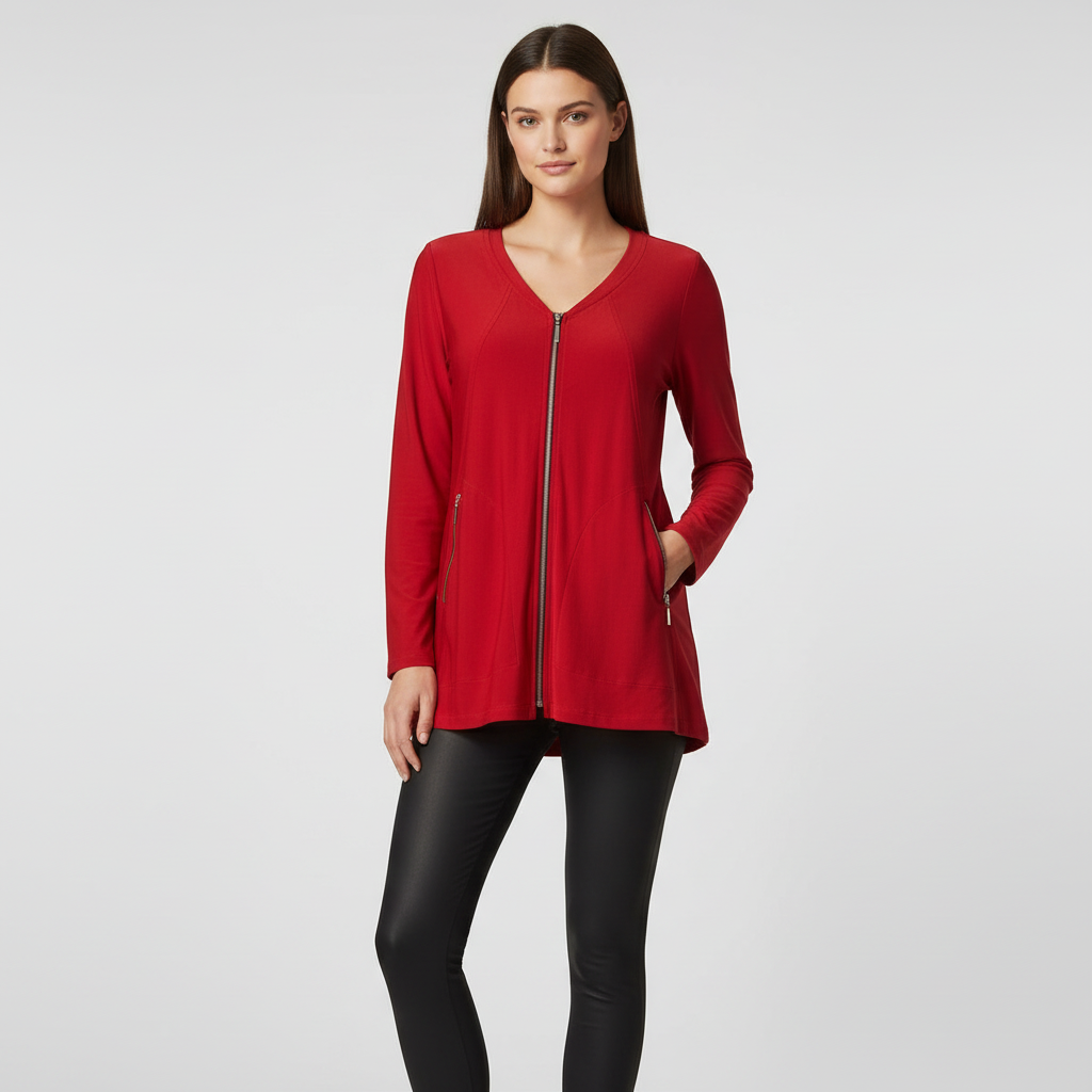 Woman wearing vibrant red zip-front tunic jacket with V-neckline and zipper pockets, hip-length fit, styled over black pants in studio setting