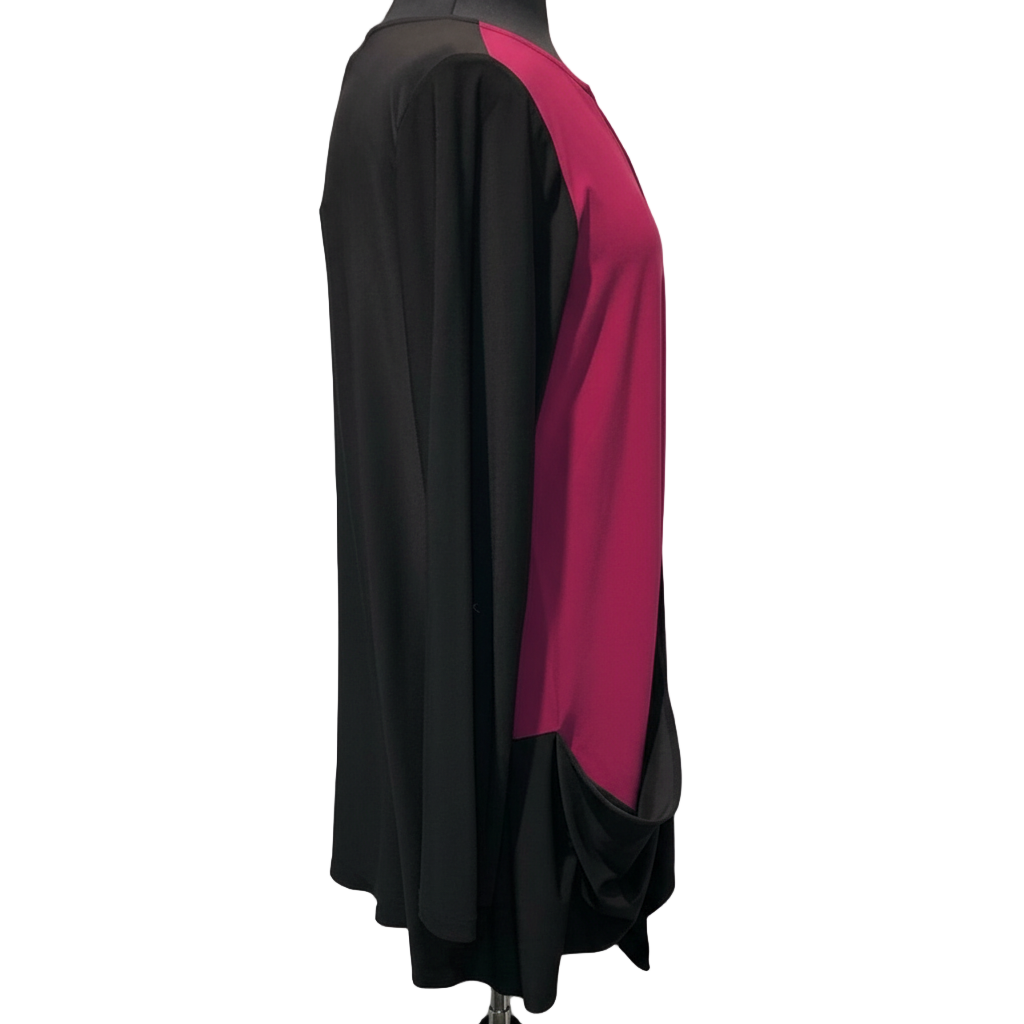 Side view of black and rose statement pocket tunic on dress form displaying pink accent panel and black draped pocket