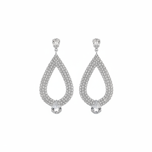 Silver rhinestone teardrop dangle earrings with crystal pavé and pear-shaped drop on white background
