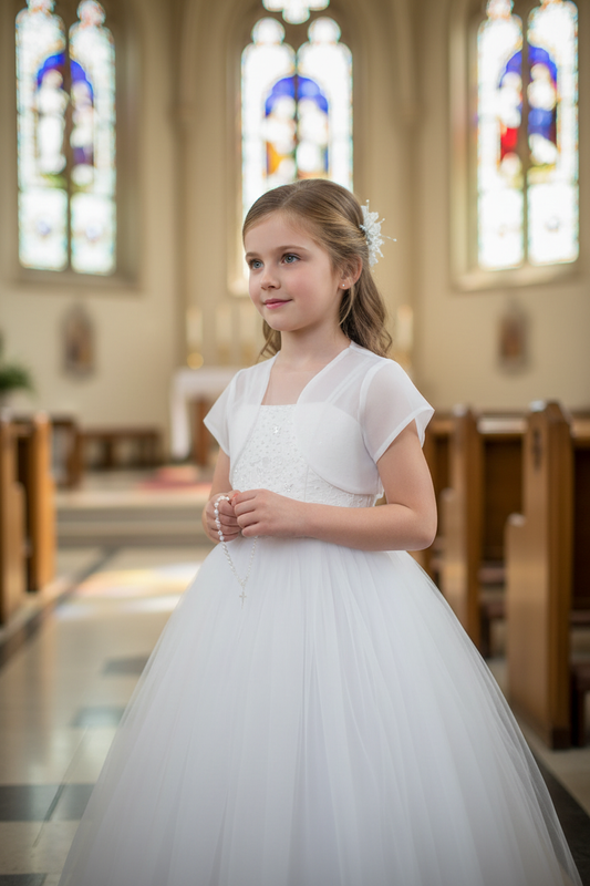 Young girl wearing white organza bolero over formal dress at special occasion - girls communion or wedding accessory lifestyle photography