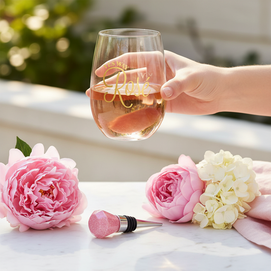 Woman holding Yes Way Rosé wine glass with pink gemstone stopper on marble surface - gold foil wine gift set