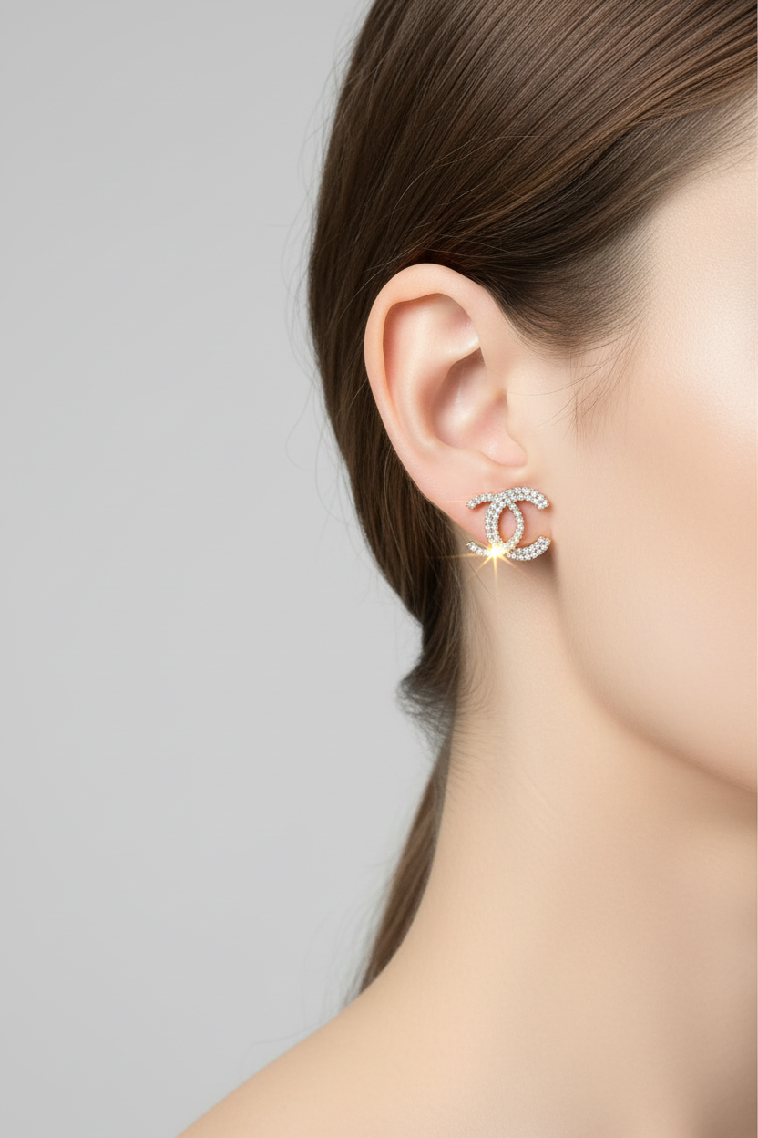 Woman wearing rhinestone C stud earring with sparkling pavé crystals in interlocking C design